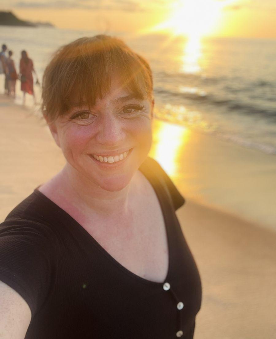 Meghan Gough smiling on a beach at sunset